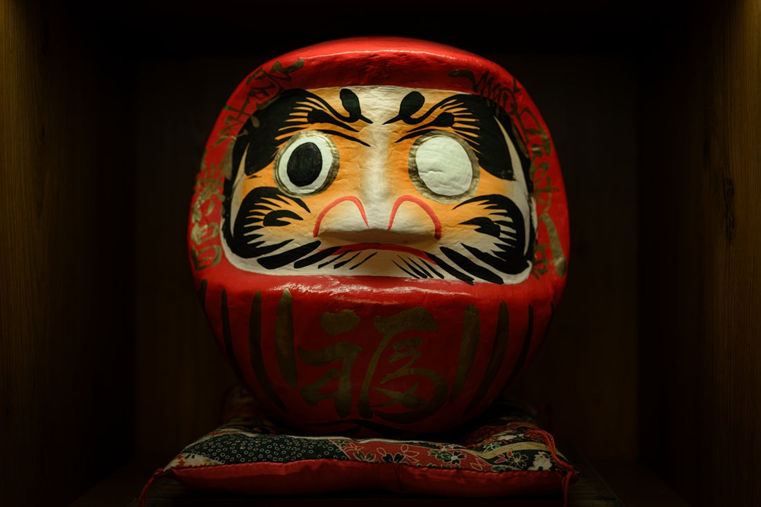 A red daruma doll with one eye missing
