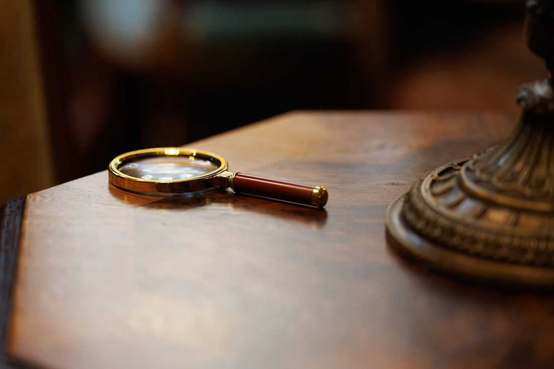 Magnifying glass resting on a wooden surface