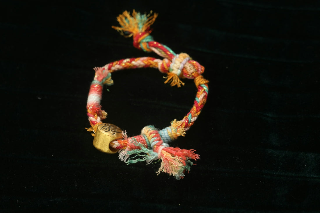Colorful braided rope bracelet with gold accent