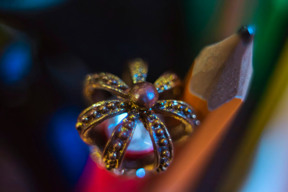 A decorative crown sits atop a sharpened pencil tip