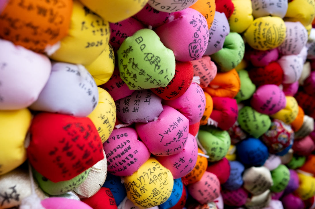 Wall of colorful good luck charms with japanese writing