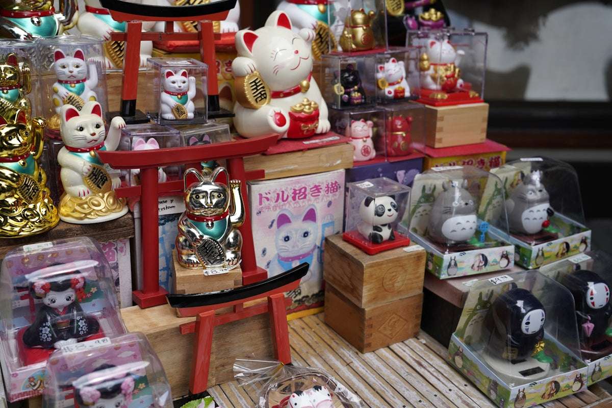 Collection of lucky cat figurines and other small ornaments.