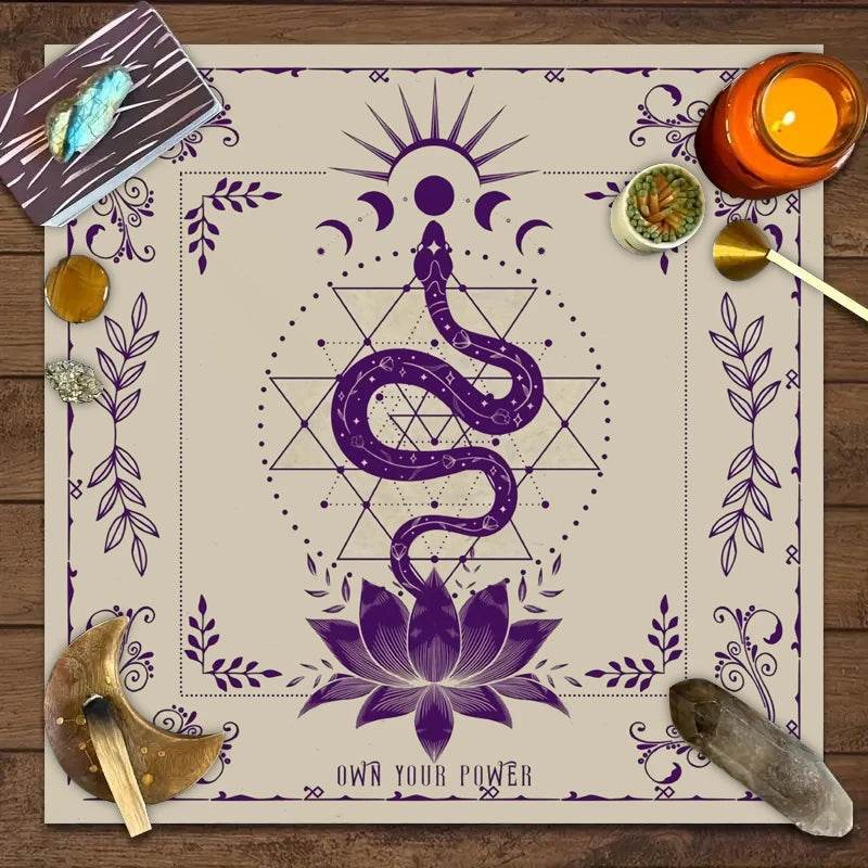 Purple snake and lotus design on cream astrology tarot tablecloth with moon phases crystals and candle