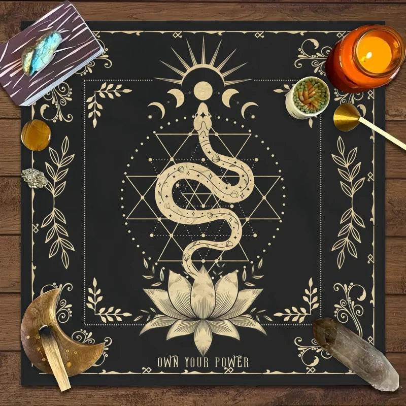 Black astrology tarot tablecloth with beige serpent rising from lotus geometric star pattern moon phases and crystals