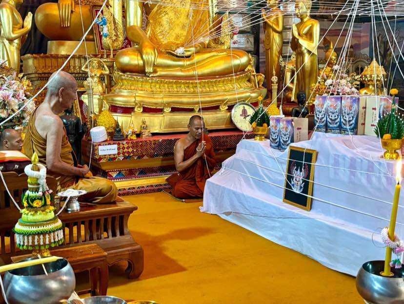 Ceremony featuring monks blessing an authentic Thai guardian amulet for spiritual protection