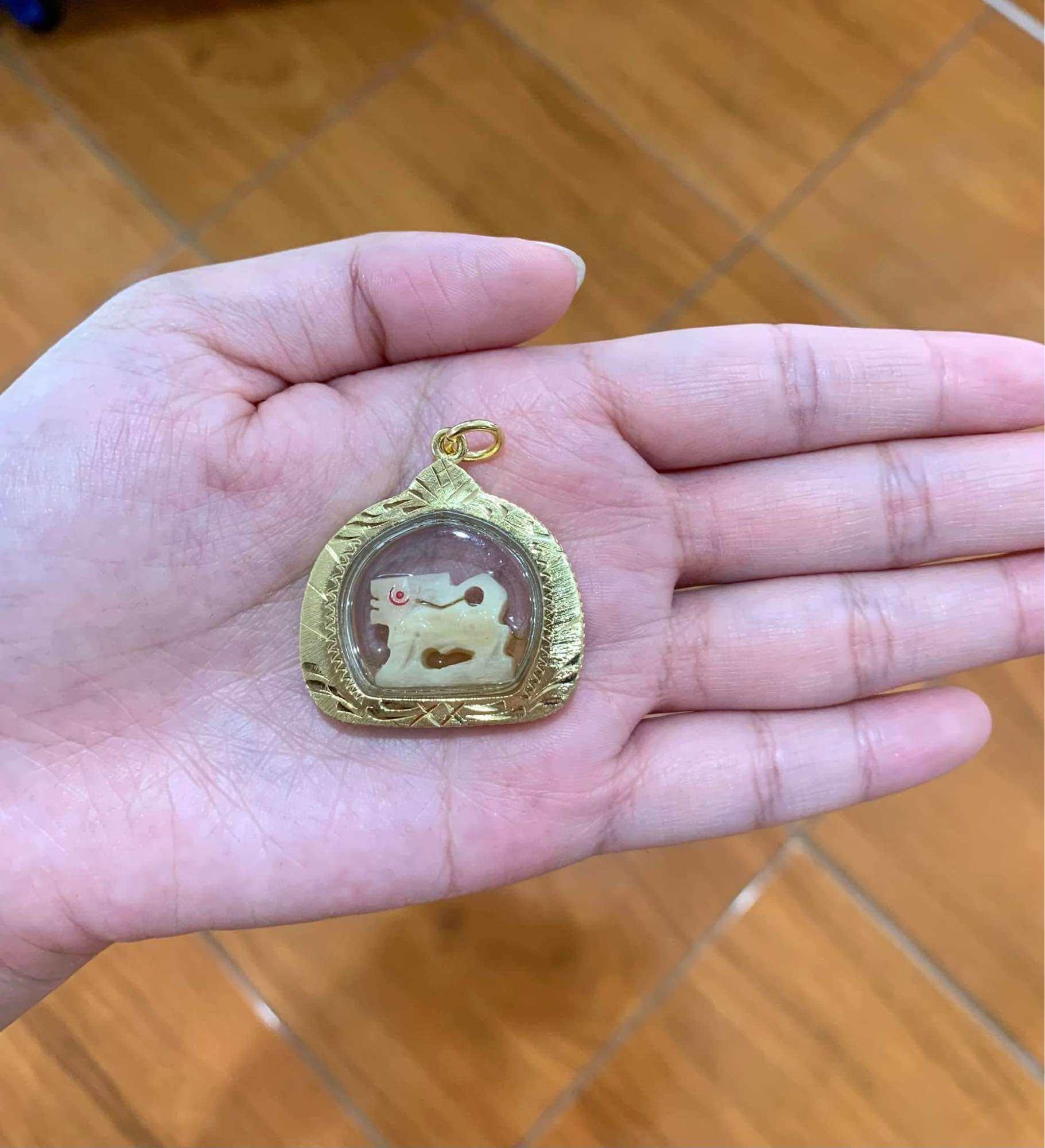 Carved Bone Singha Amulet with Musk Oil Coating - Blessed by Luang Pu Im of Wat Thung Na Mai, Nakhon Si Thammarat
