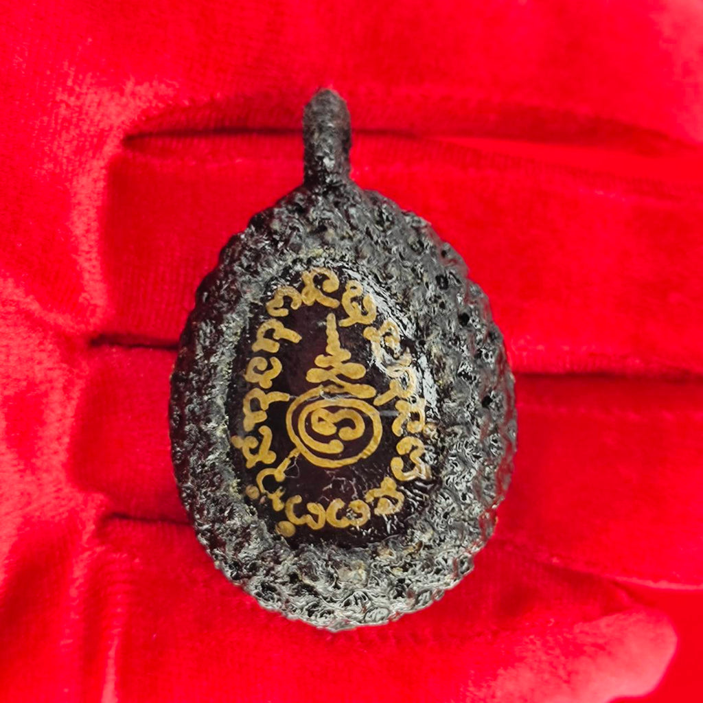 Bia Gae amulet for protection with intricate designs on a textured surface, perfect for spiritual use