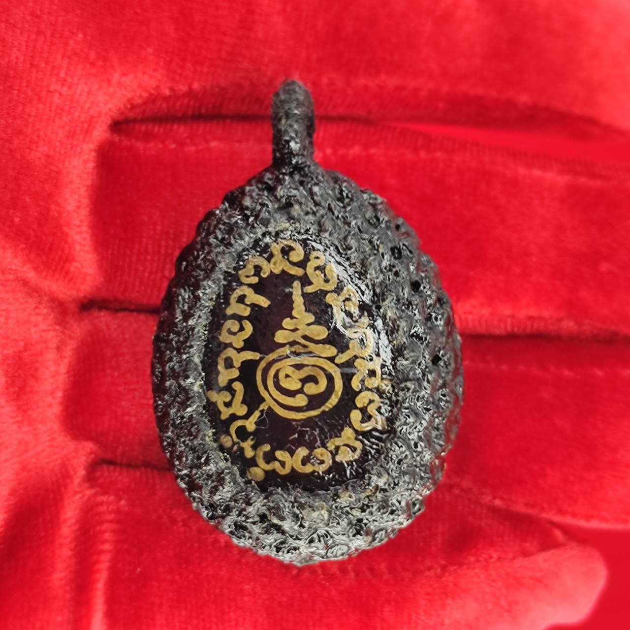 Bia Gae amulet for protection with intricate designs on a textured surface, perfect for spiritual use