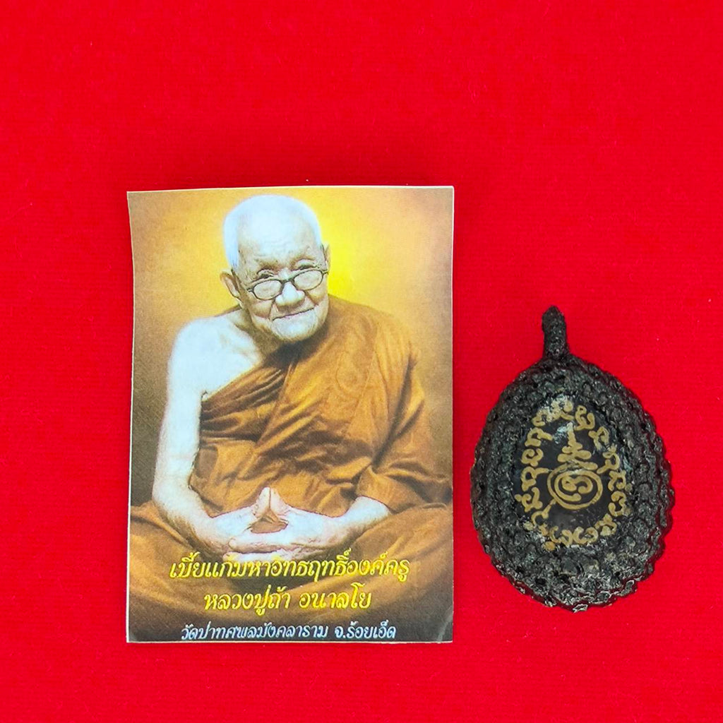 Bia Gae amulet for protection with an image of a monk on a red background