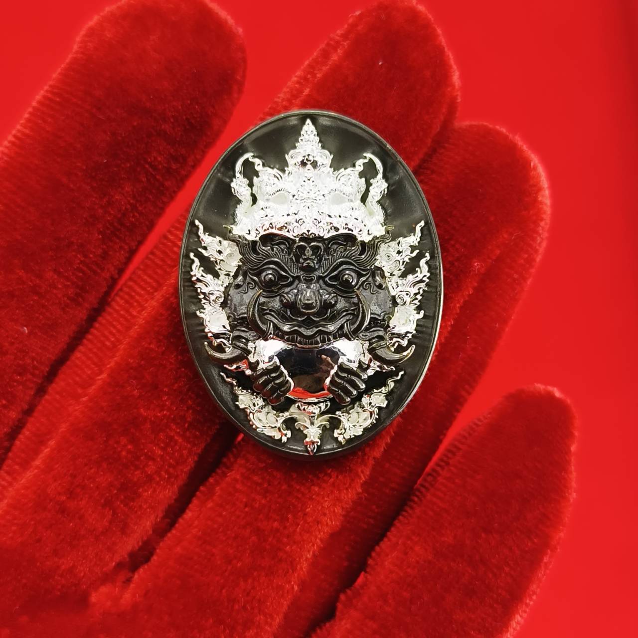 Rahu amulet coin for prosperity featuring intricate designs and a protective deity image