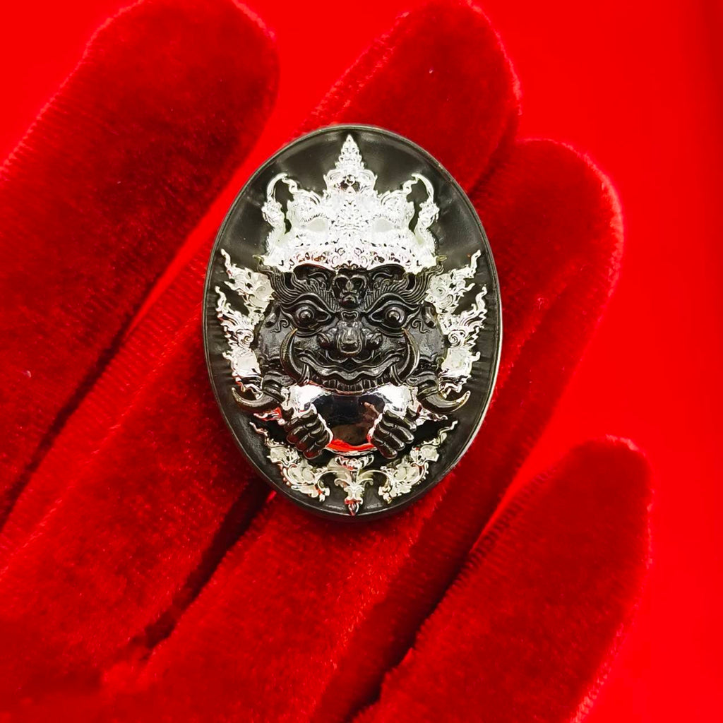 Rahu amulet coin for prosperity featuring detailed design on a red background