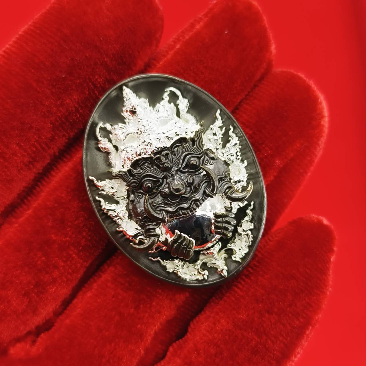 Rahu amulet coin for prosperity featuring intricate design and vibrant details on a red background