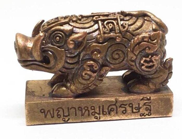 Phaya Moo Setthi bronze pig amulet statue with intricate Thai carvings on rectangular base with Thai script