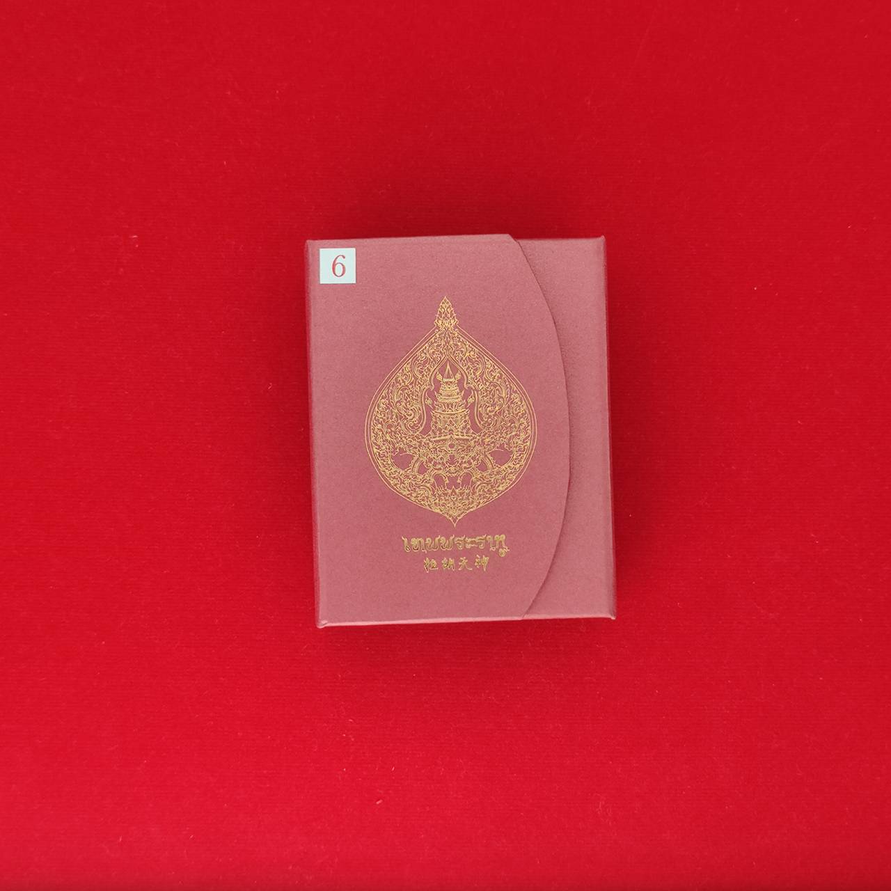 Rahu amulet for fortune packaged in an elegant red box featuring gold embossed design