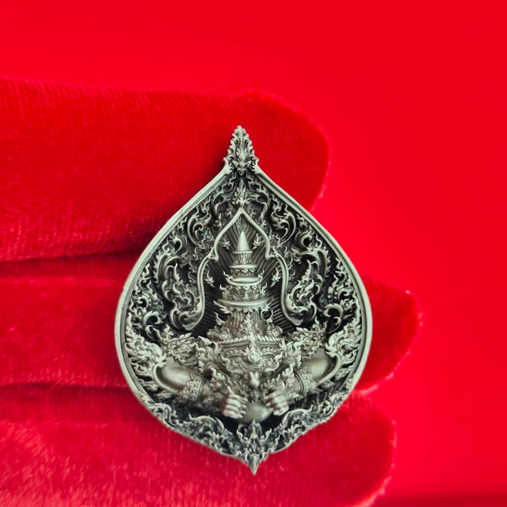 Rahu amulet for fortune intricately designed in silver with detailed spiritual motifs
