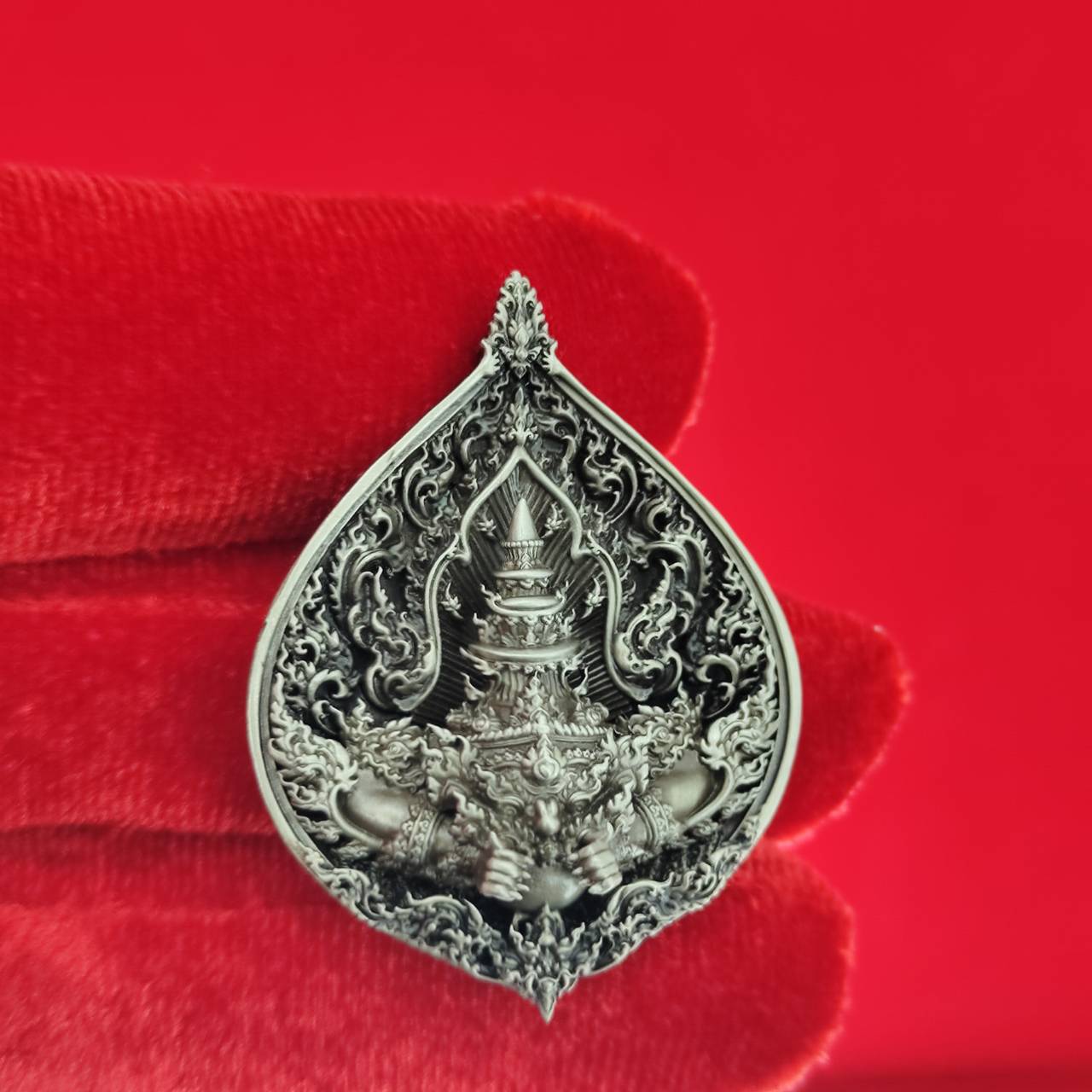 Rahu amulet for fortune intricately designed in silver with detailed spiritual motifs