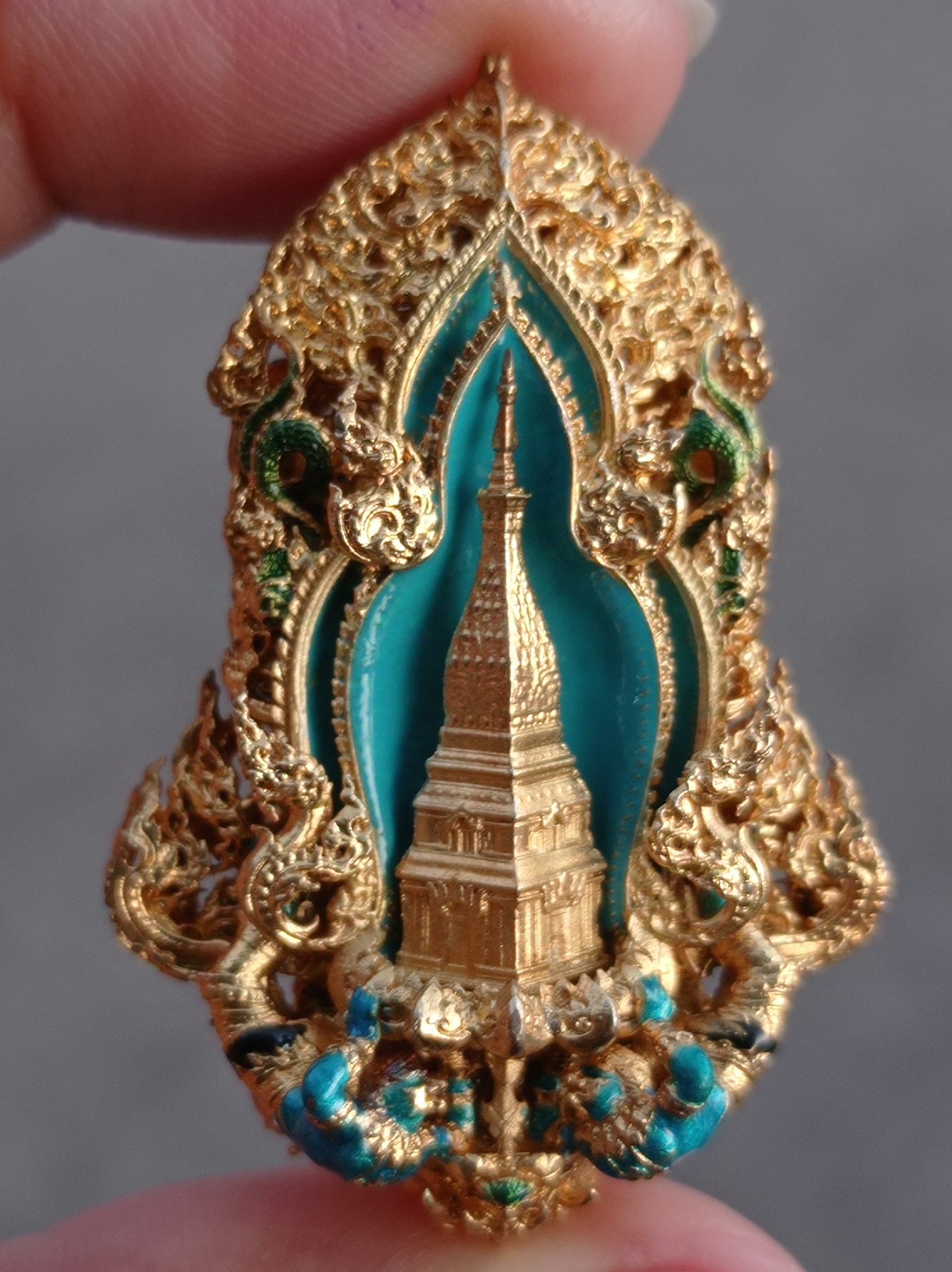 Thao Wessuwan amulet for protection featuring intricate gold detailing and a temple design