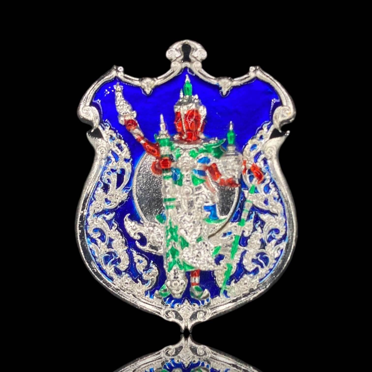 Silver enamel shield amulet with red green warrior figure on blue background Thao Wessuwanno Sodaprom .
