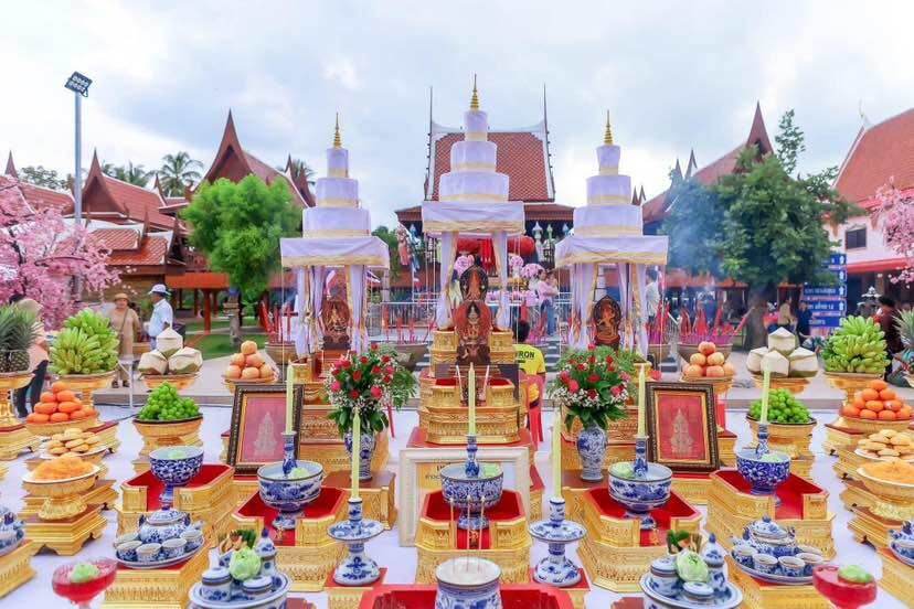 Thao Wessuwanno Sodaprom amulet statue on ornate Thai offering altar with fruits flowers and incense
