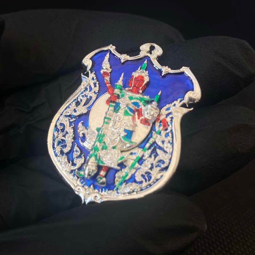 Ornate silver enamel amulet with red green guardian figure on blue shield collectible ornament Thao Wessuwanno Sodaprom .