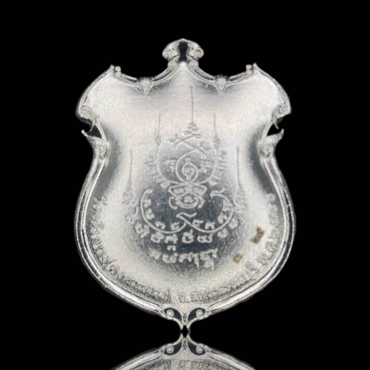 Silver shield amulet pendant with engraved Thai emblem and script Thao Wessuwanno Sodaprom . ornate devotional ornament