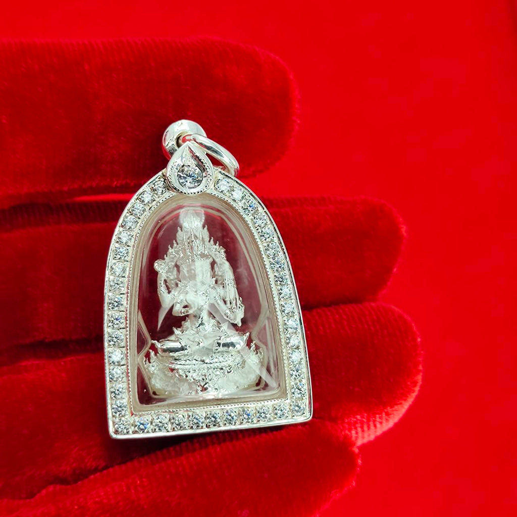 Brahma Naga amulet with silver frame pendant featuring detailed deity inside crystal case held on red velvet glove