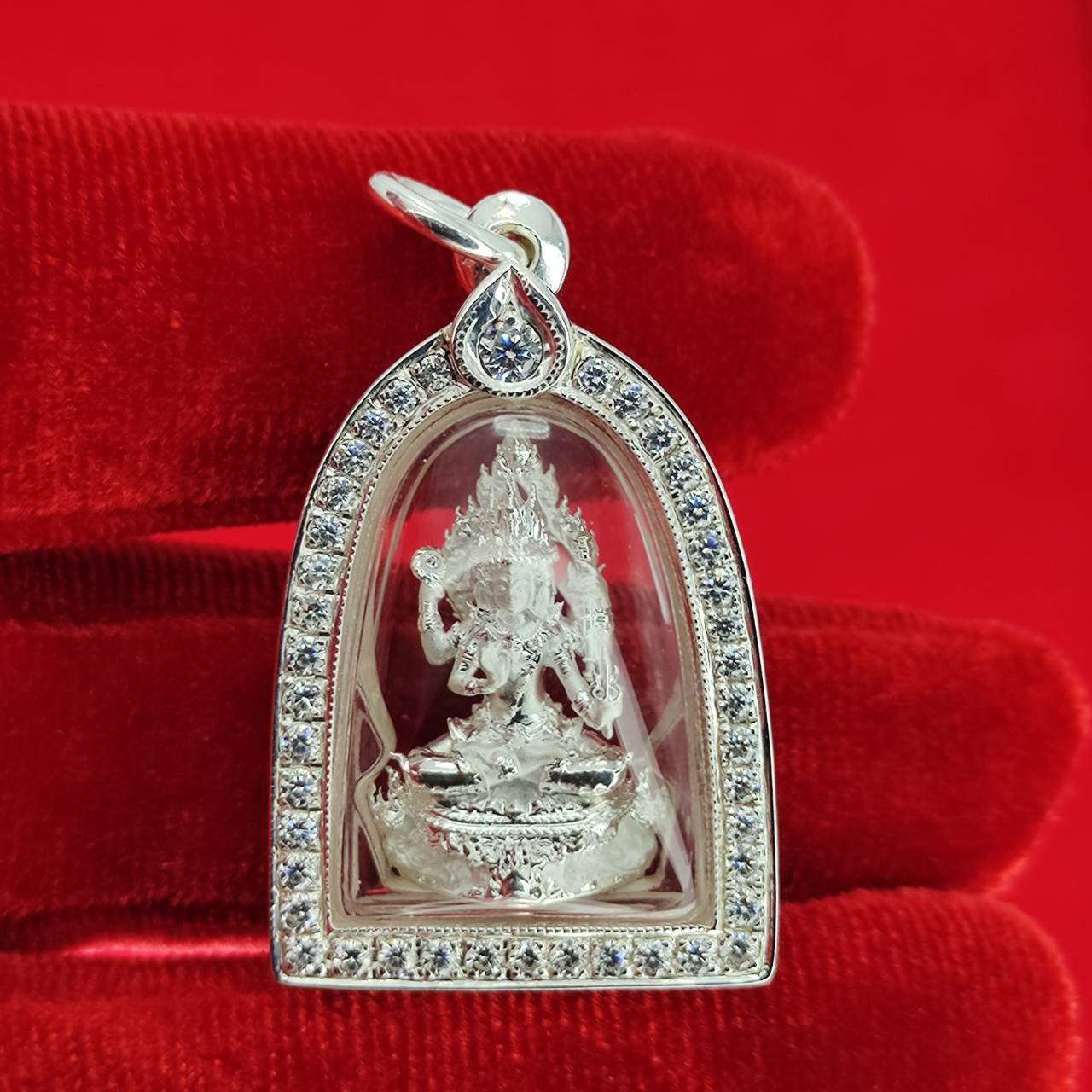 Brahma Naga amulet with silver frame pendant featuring detailed silver Brahma statue in gemset bezel on red velvet