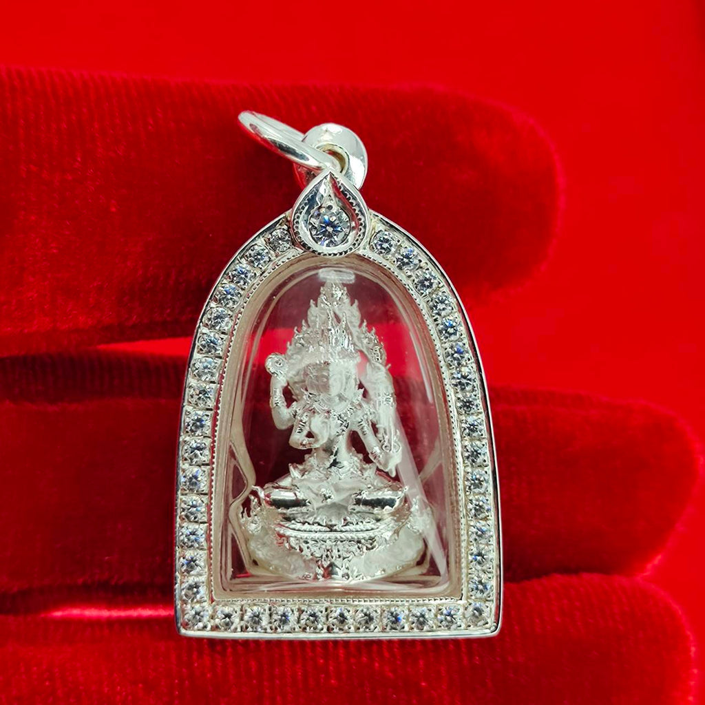 Brahma Naga amulet with silver frame pendant in jeweled silver case on red velvet background