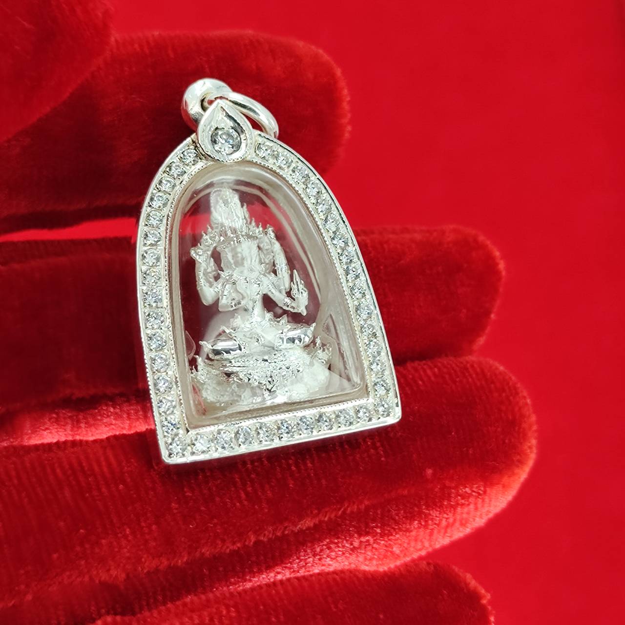 Brahma Naga amulet with silver frame. Thai Blessing Co jeweled silver pendant amulet on red velvet