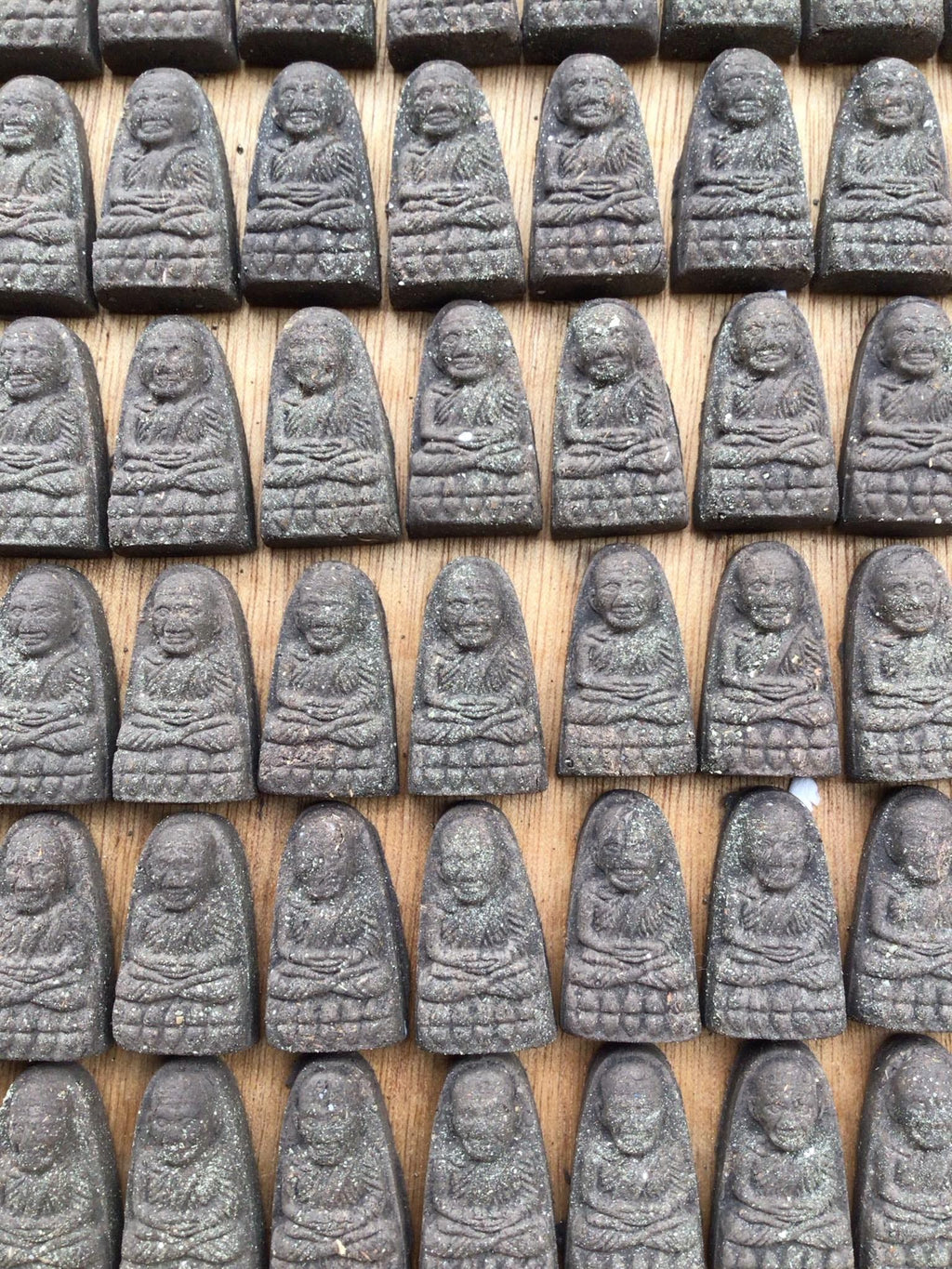 Thai Blessing Co multiple Luang Pu Thuad commemorative amulet 2023 pendants arranged in rows on wood