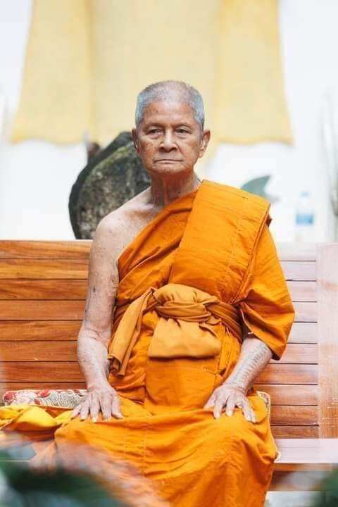 Thai monk seated in saffron robes used in Luang Pu Thuad commemorative amulet 2023 listing by Thai Blessing Co