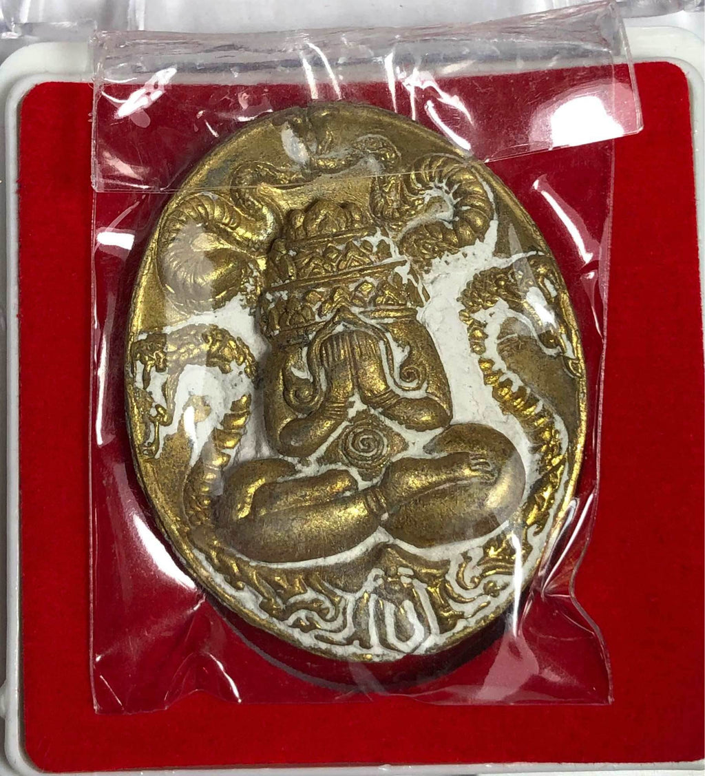 Maharaj Phangphakarn amulet Phaya Chingchai edition gold oval pendant with seated meditative figure and naga serpents in red box