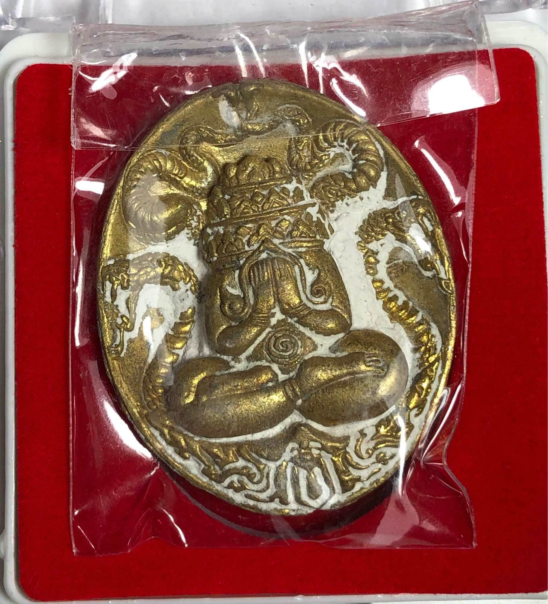 Maharaj Phangphakarn amulet Phaya Chingchai edition gold oval pendant with seated meditative figure and naga serpents in red box