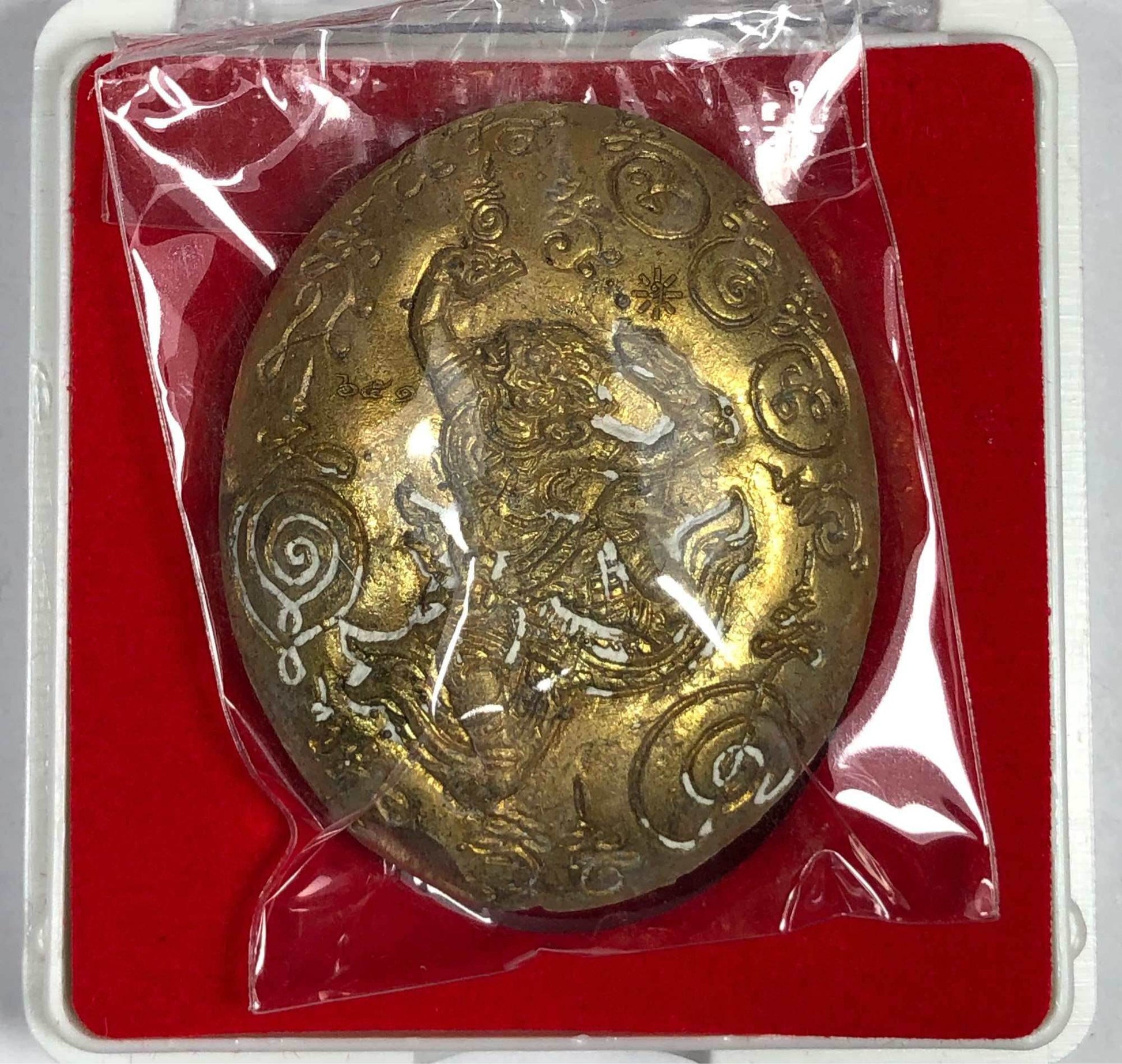 Maharaj Phangphakarn amulet Phaya Chingchai edition gold oval pendant with engraved deity in plastic pouch on red velvet box