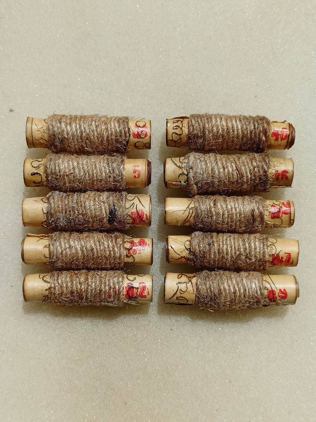 Thai Blessing Co sacred protection charm for fortune set of ten twine wrapped Buddhist scroll amulets