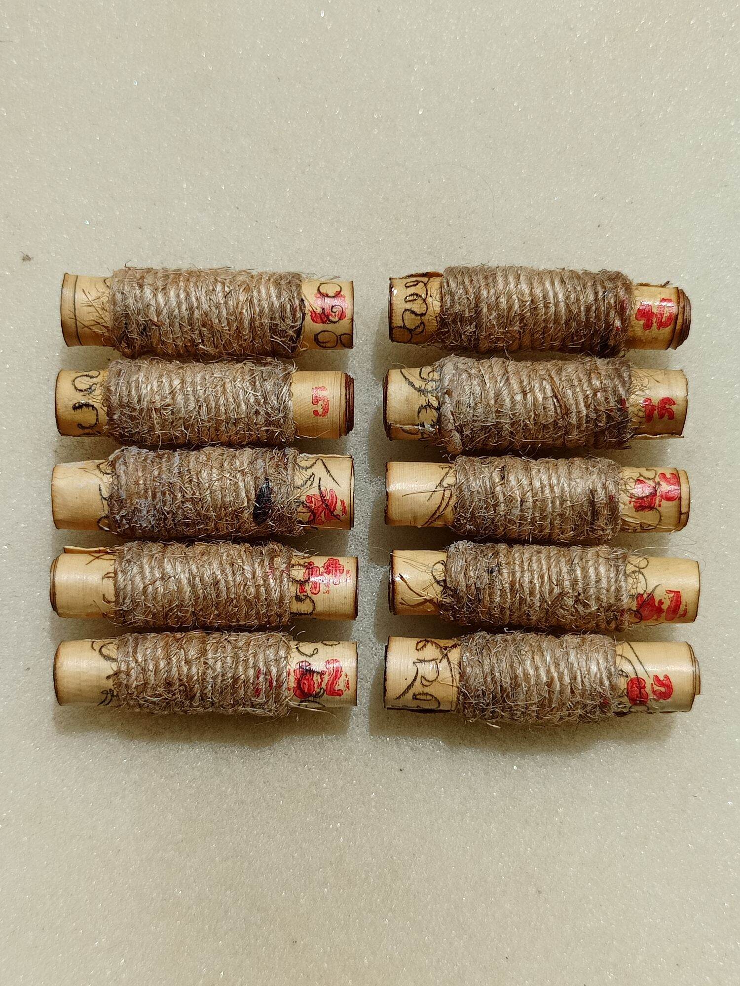 Thai Blessing Co sacred protection charm for fortune set of ten twine wrapped Buddhist scroll amulets