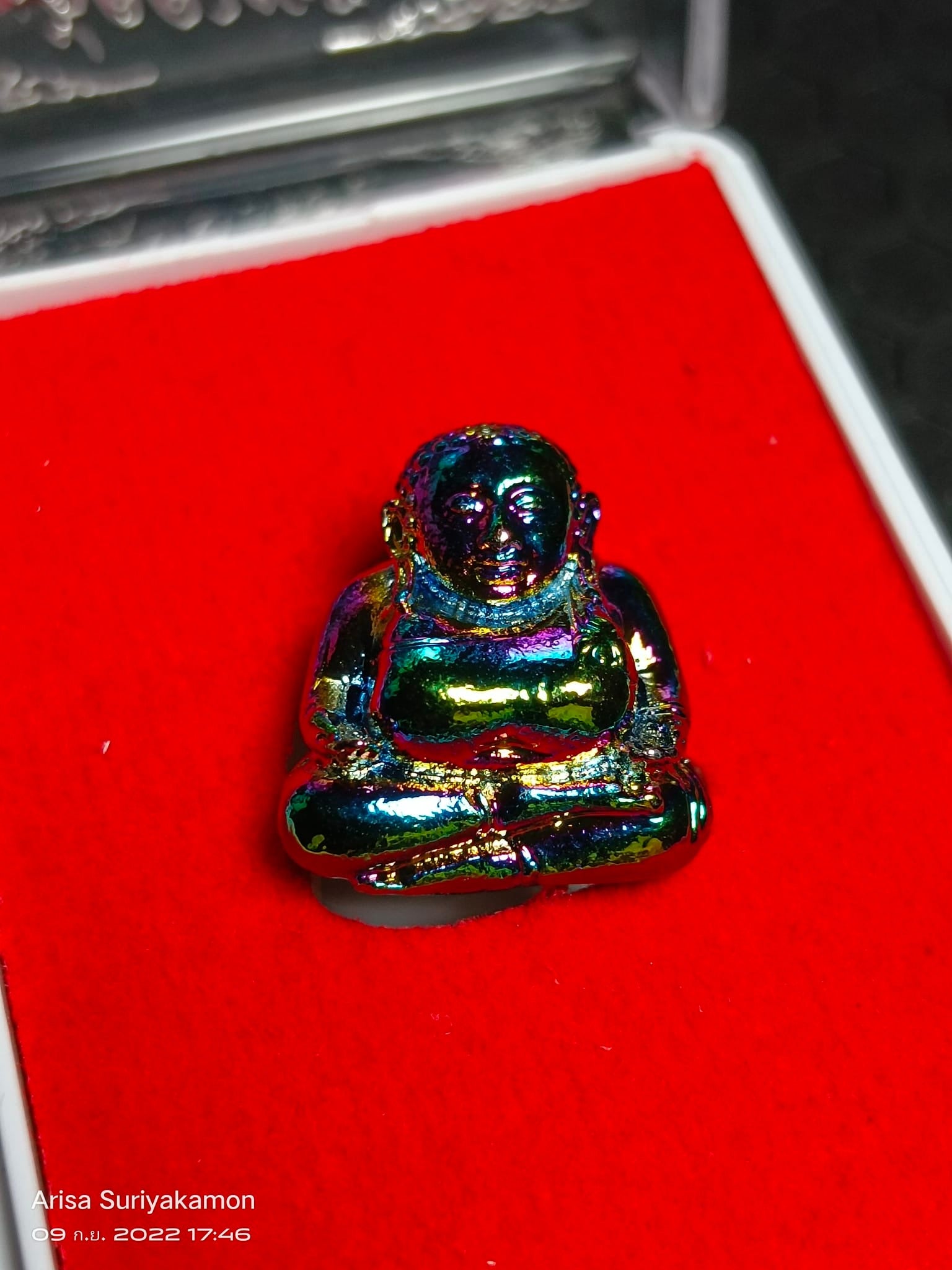 Sangkajai Buddha amulet for wealth iridescent metal small seated amulet on red velvet display box