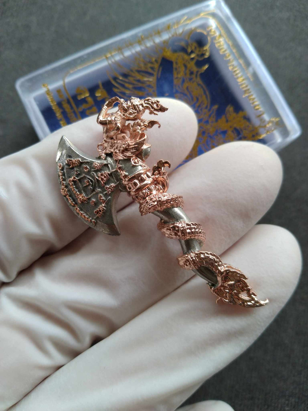 Sky Axe Krut Thawet amulet copper and silver axe pendant with intricate Garuda and serpent details held in gloved hand