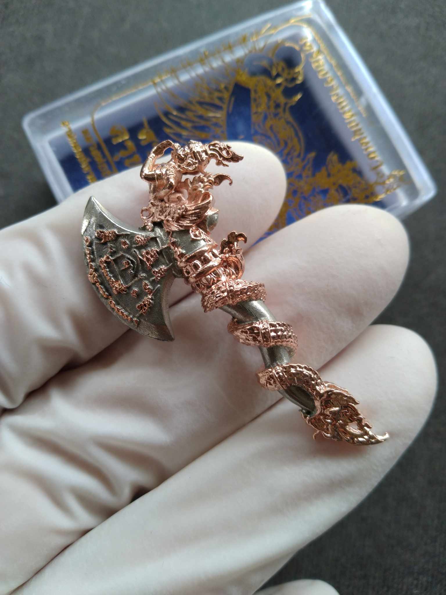 Sky Axe Krut Thawet amulet copper and silver axe pendant with intricate Garuda and serpent details held in gloved hand