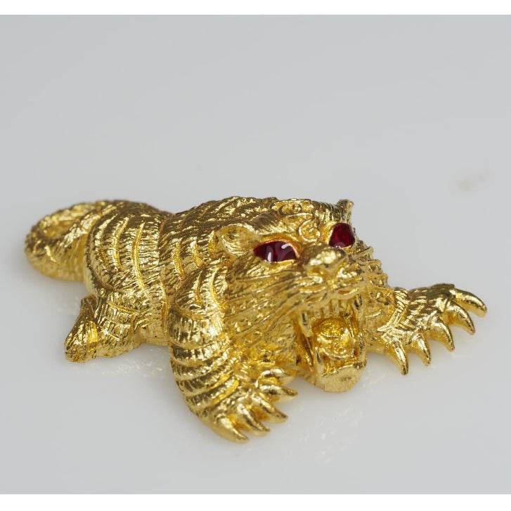 Gold tiger amulet with red gemstone eyes and textured claws Thai amulets for wealth decorative blessing