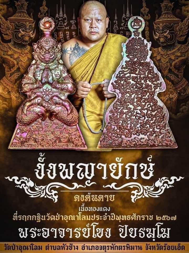 Thai guardian spirit protection charm pendant display featuring ornate pink metal amulets with monk and temple backdrop