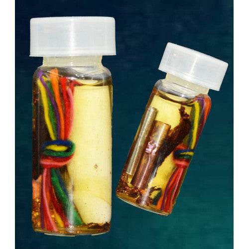 Two small glass vials with braided multicolor cords rolled paper and metal tubes in oil Thai love and fortune talisman