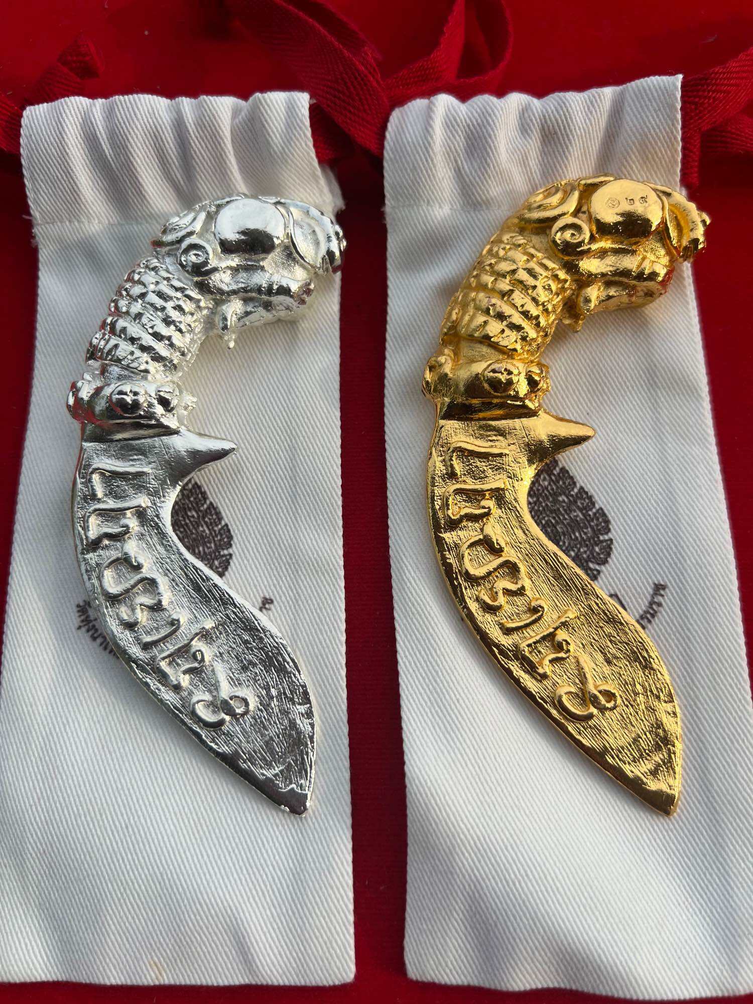 Thai mitmor dagger for protection silver and gold fish handle amulets on white pouches by Thai Blessing Co