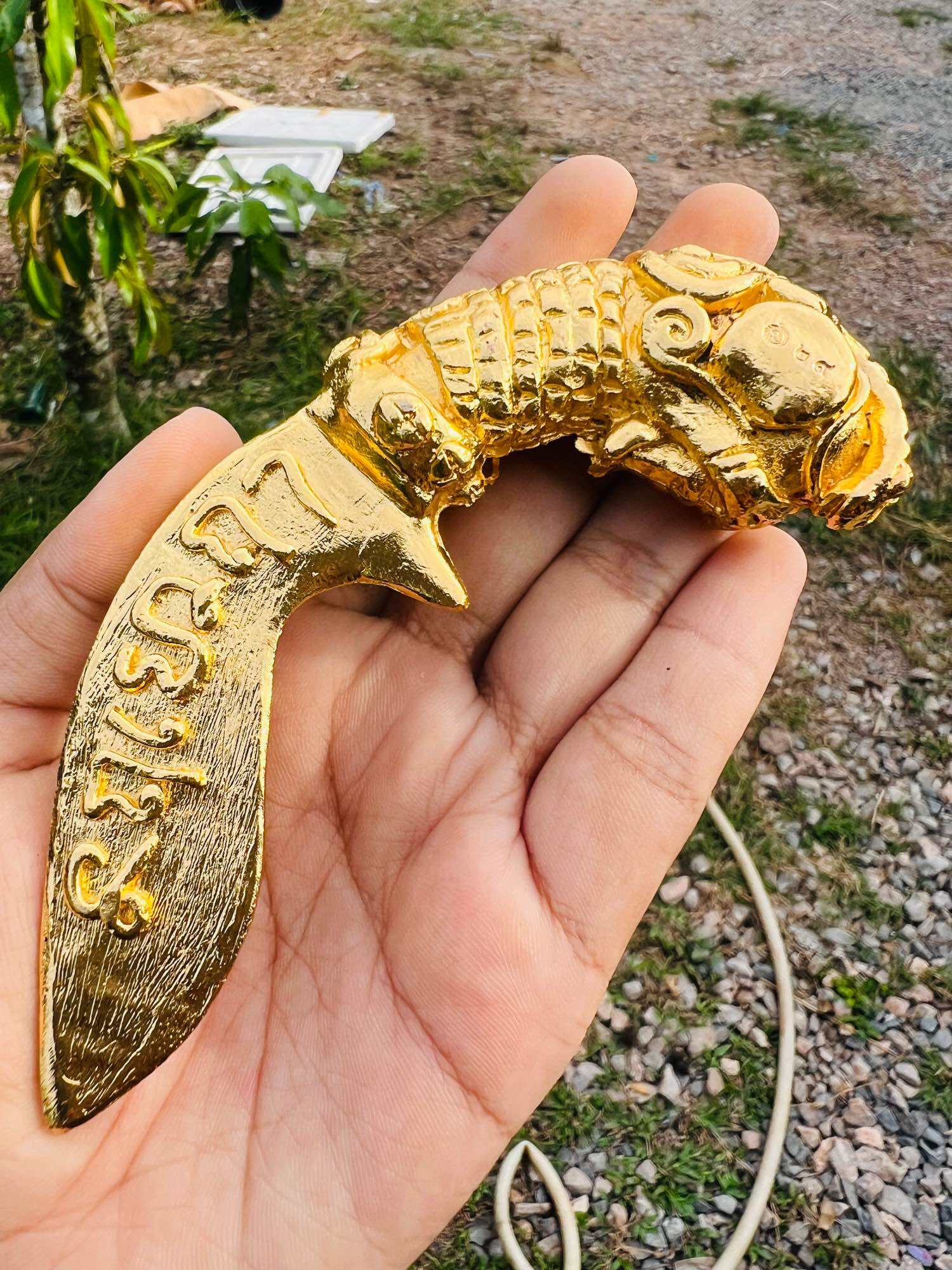 Handheld gold Thai mitmor dagger for protection amulet statue with ornate carved mythical handle