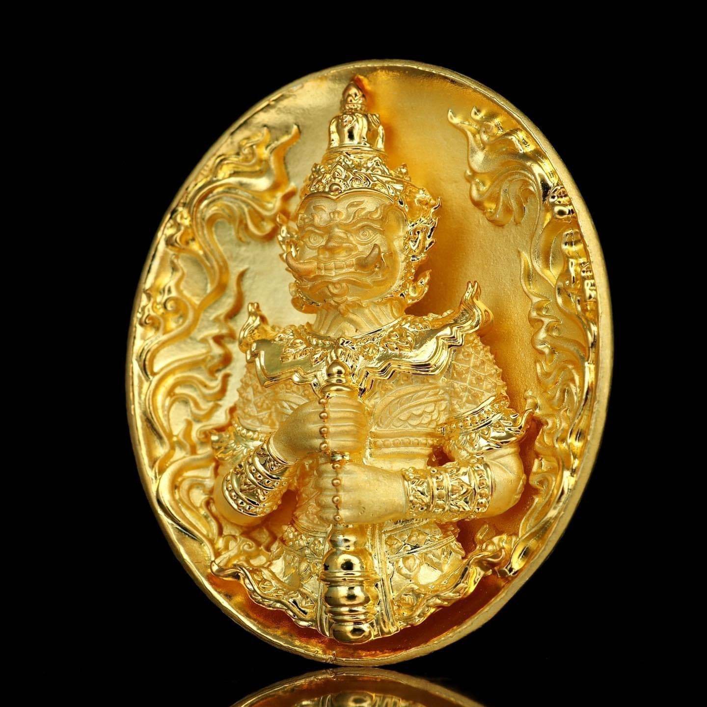 Gold amulet medallion of guardian giant holding club ornate details black background Thao Wessuwanno Bandarn Patthanapon