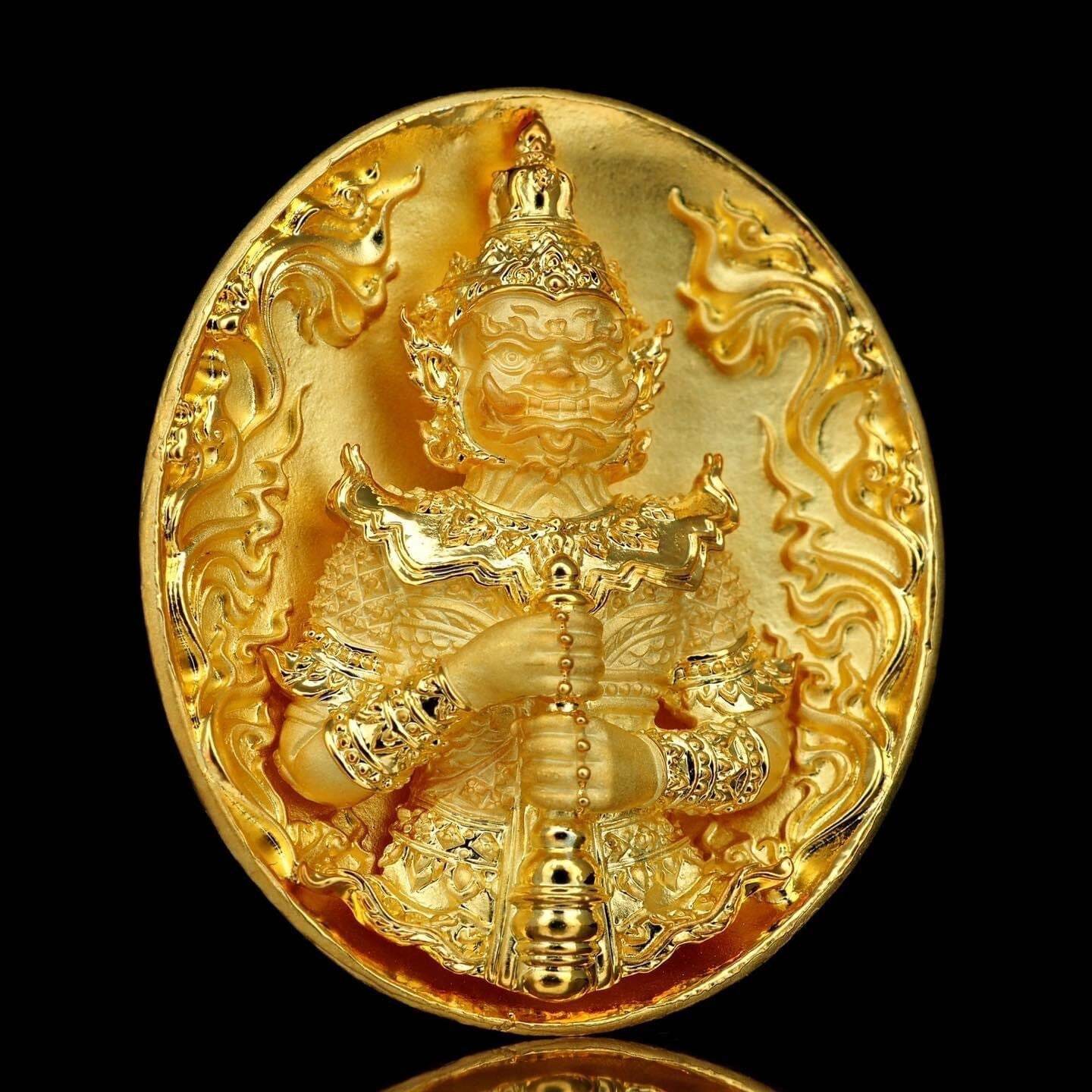 Gold oval amulet medallion featuring Thao Wessuwanno Bandarn Patthanapon guardian figure holding staff on black