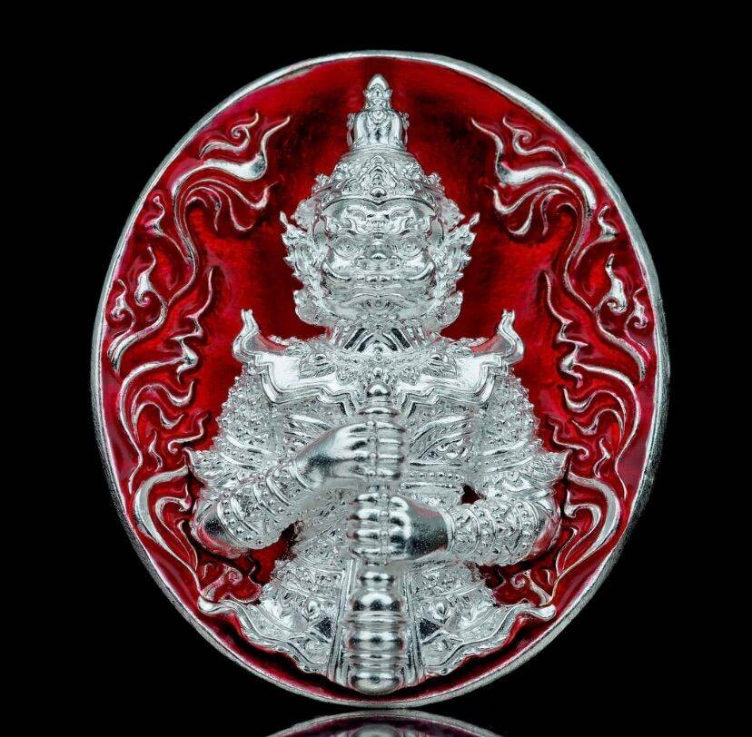 Silver amulet medallion depicting Thao Wessuwanno Bandarn Patthanapon guardian figure on red enamel