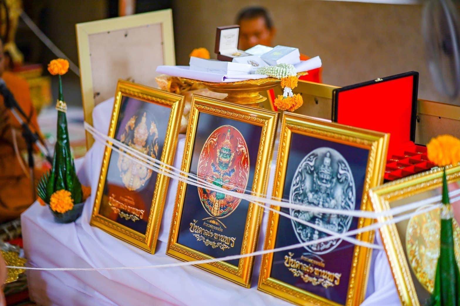 Thao Wessuwanno Bandarn Patthanapon framed amulet plaques in gold frames on ceremonial table with marigolds