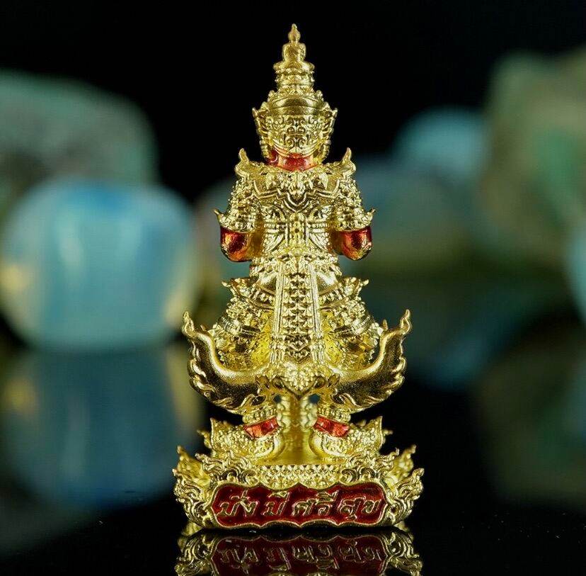 Gold Thao Wessuwanno . Thai guardian amulet figurine with red enamel accents and ornate tiered detailing
