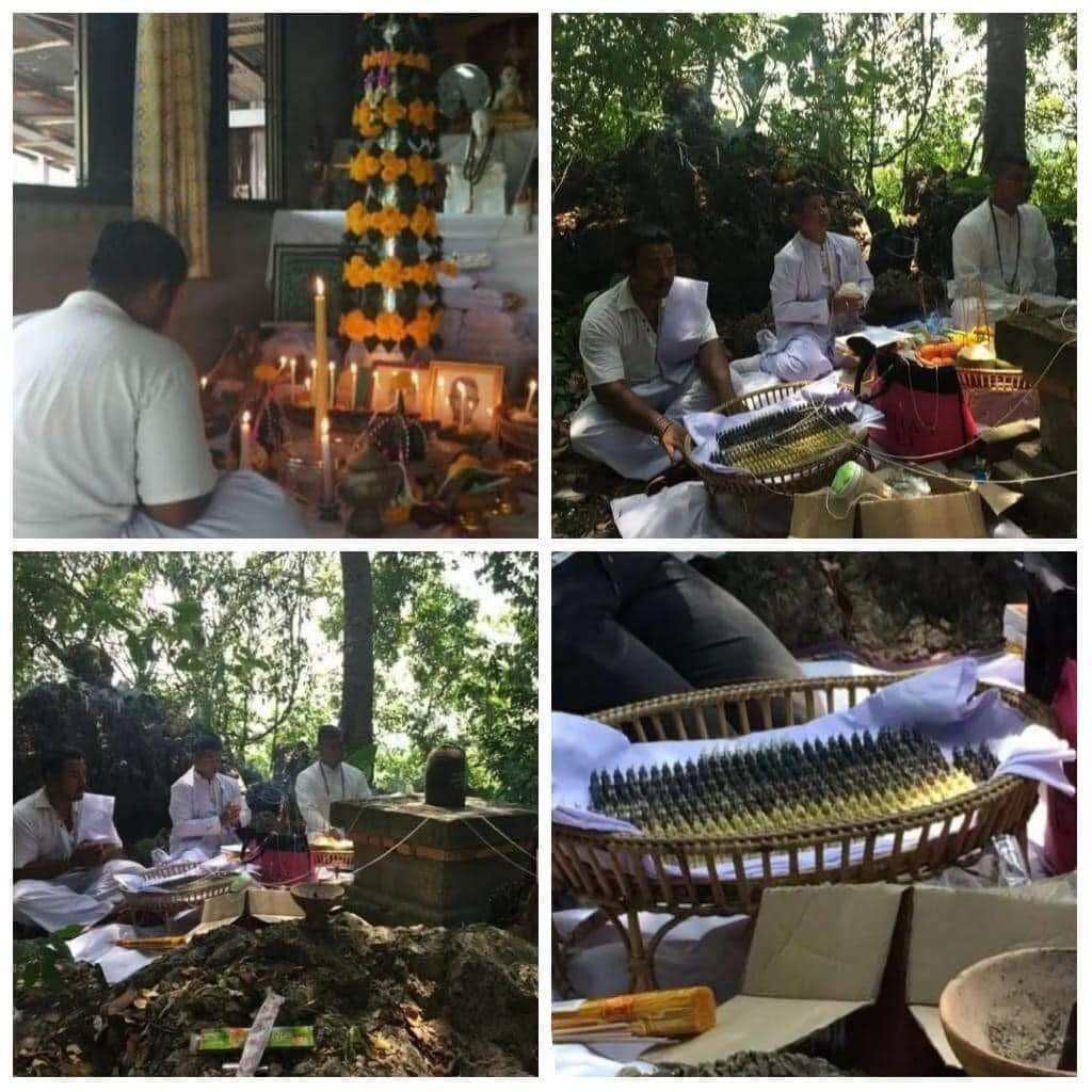 Wua Thanu Thai protection amulet ceremony with monks and offerings in forest showing baskets of amulets